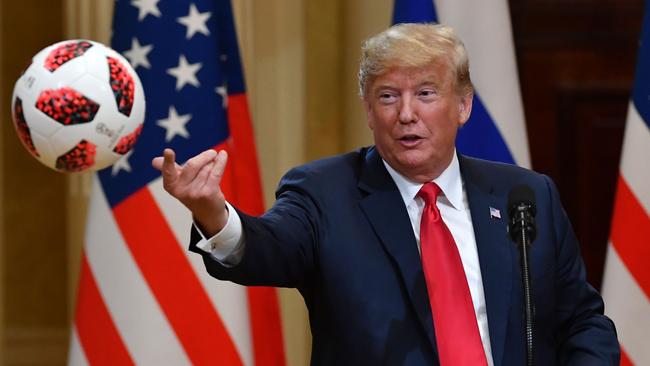 Donald Trump throws a ball during a press conference on the 2018 football World Cup in Helsinki