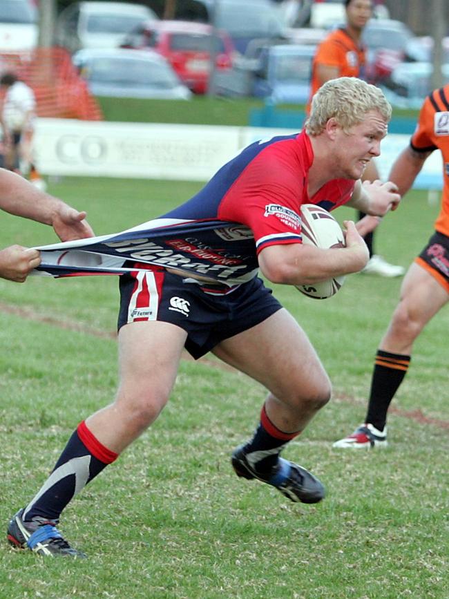 Rugby League. Southport (orange) vs, Runaway Bay at Southport Tigers. Photo of Brendan Hoare is pulled back by Chris Hodges