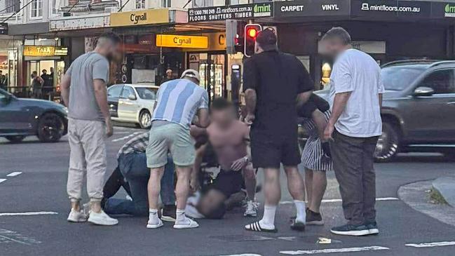 People are pictured around a man that was fatally shot at Cleveland Street and Crown Street in an underworld shooting. Picture: supplied.