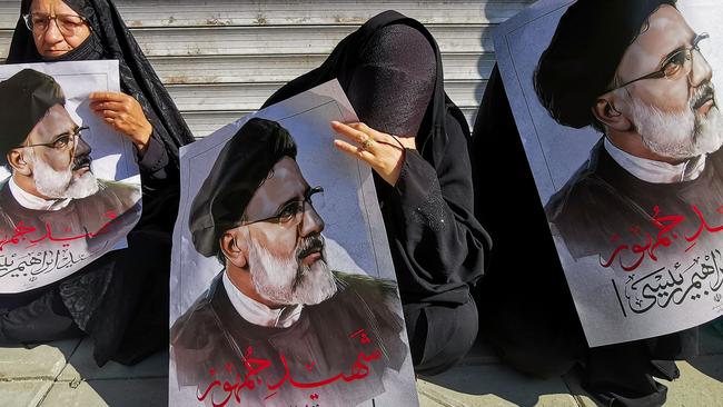 Mourners hold posters of Iranian President Ebrahim Raisi during a funeral ceremony in Tehran, on May 22. Picture: AFP