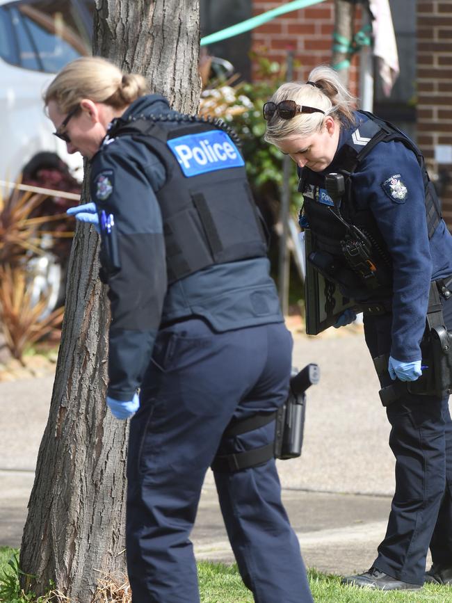 Police comb the scene for evidence. Picture: Tony Gough