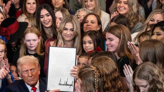 US President Donald Trump holds up the No Men in Women's Sports Executive Order. Picture: Andrew Caballero-Reynolds/AFP