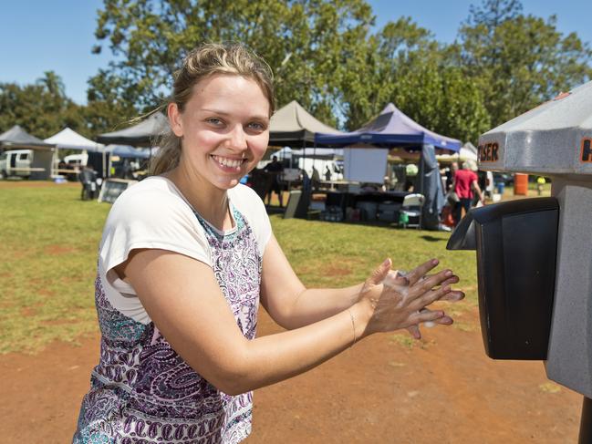 Laura Ayles of The Toowoomba Farmers Market uses the hand sanitiser dispenser placed by organisers as part of measures to reassure the public in the wake of the COVID-19 coronavirus pandemic, Saturday, March 21, 2020. Picture: Kevin Farmer