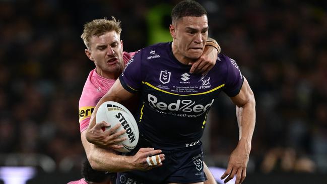 SYDNEY, AUSTRALIA - OCTOBER 06: Will Warbrick of the Storm is tackled by Luke Garner and Sunia Turuva of the Panthers during the 2024 NRL Grand Final match between the Melbourne Storm and the Penrith Panthers at Accor Stadium on October 06, 2024, in Sydney, Australia. (Photo by Quinn Rooney/Getty Images)