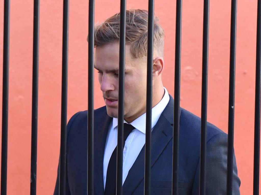 St. George Illawarra Dragons player Jack de Belin is seen walking behind a fence as he arrives at Wollongong Local Court on Tuesday (AAP Image/Dean Lewins)