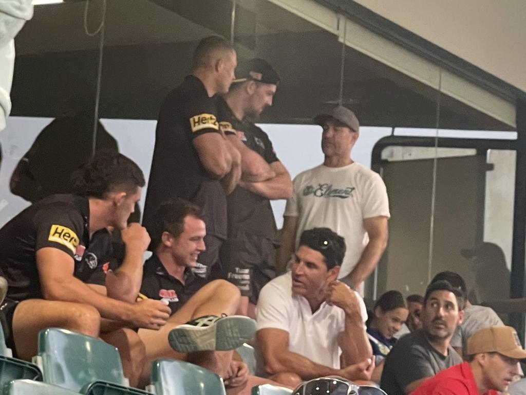 Trent Barrett in the stands talking to the Panthers' Dylan Edwards and Nathan Cleary.