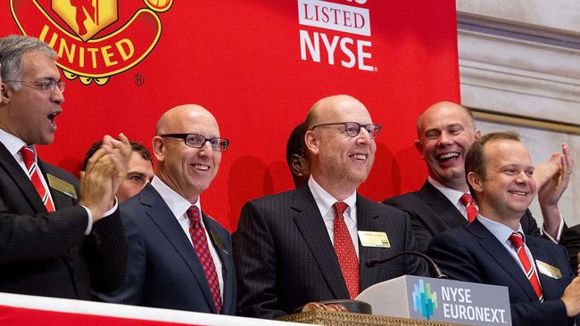 Manchester United Executives Joel Glazer (2nd L) and Avram Glazer (C).