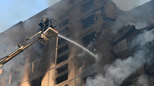 Ukrainian rescuers work to extinguish a fire in a residential building following a missile attack in Kharkiv on August 30. Picture: AFP