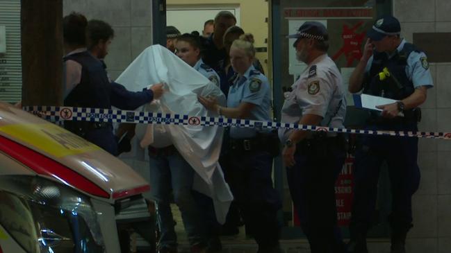 The young girl is carried from the dance studio with a sheet over her to protect her identity. Picture: TNV