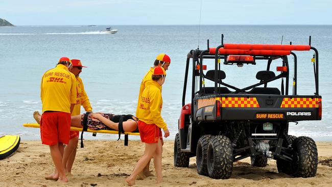 Point Lonsdale Surf Life Saving Club members run a training drill on the beach.