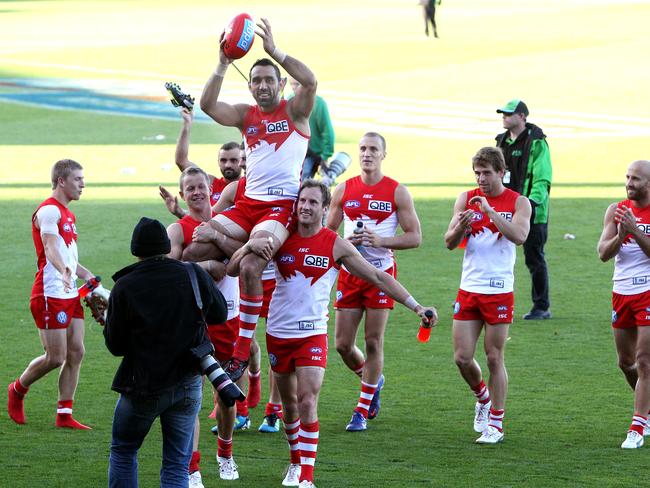 Adam Goodes is chaired off after breaking the Swans’ games record.