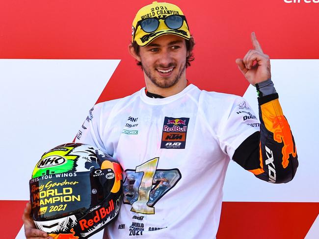 Kalex Red Bull KTM Ajo Australian rider Remy Gardner celebrates his Moto2 2021 World Champion title, after the Moto2 race of the Valencia Grand Prix at the Ricardo Tormo racetrack in Cheste, on November 14, 2021. (Photo by JOSE JORDAN / AFP)