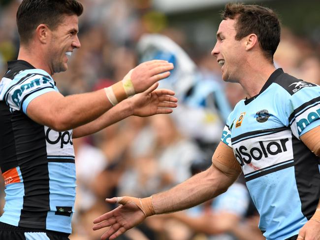 James Maloney (right) of the Sharks is congratulated by Chad Townsend after scoring a try during the round 7 NRL match between the Penrith Panthers and the Cronulla Sutherland Sharks at Pepper Stadium in Sydney on Sunday, April 16, 2017. (AAP Image/Paul Miller) NO ARCHIVING, EDITORIAL USE ONLY