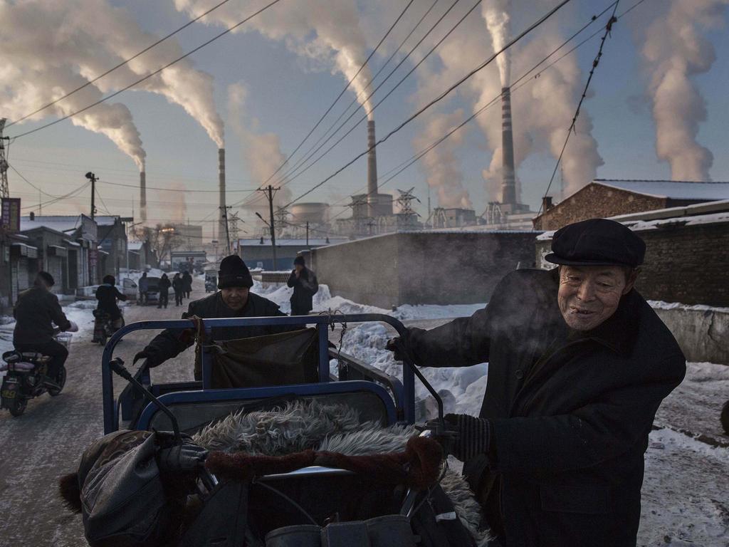 “China’s Coal Addiction” by photographer Kevin Frayer for Getty Images which won first prize in the Daily Life singles category shows Chinese men pulling a tricycle in a neighborhood next to a coal-fired power plant in Shanxi, China, on Nov. 26, 2015. A history of heavy dependence on burning coal for energy has made China the source of nearly a third of the world’s total carbon dioxide (CO2) emissions, the toxic pollutants widely cited by scientists and environmentalists as the primary cause of global warming. (Kevin Frayer/Getty Images, World Press Photo via AP)