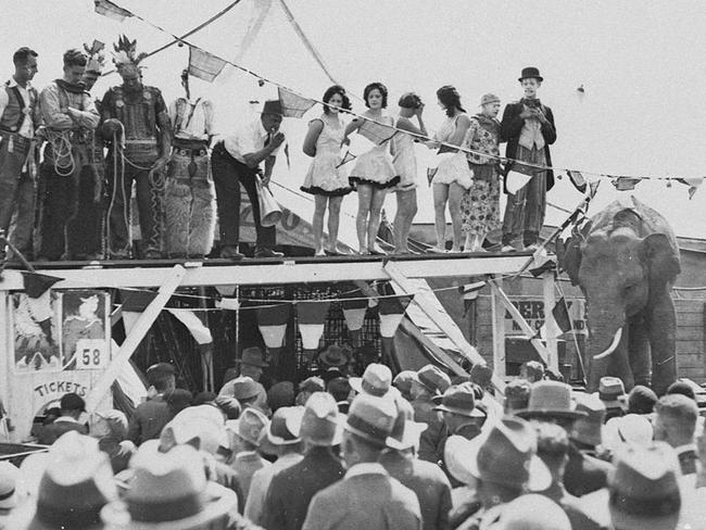 Clowns, ‘Indians’, girls and spruiker at Sideshow Alley. Picture: Sam Hood, State Library of NSW