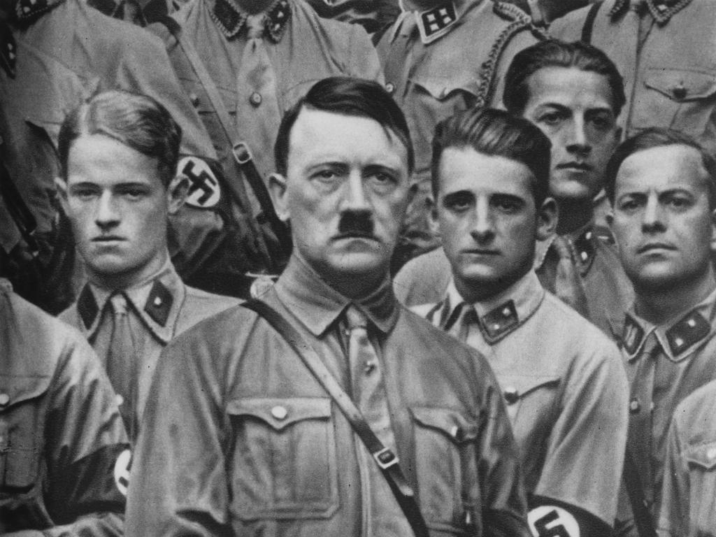 German Nazi Party Leader Adolf Hitler (1889 – 1945) with some young members of the Sturmabteilung during a rally, circa 1930. (Photo by Three Lions/Hulton Archive/Getty Images)