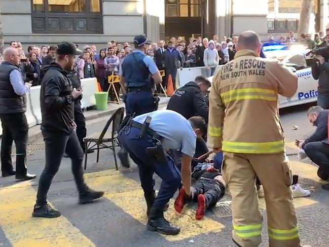 Police arrest the man after a woman was stabbed in Sydney's CBD. Picture: AAP