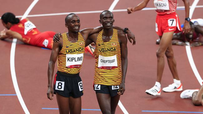 Joshua Cheptegei from Uganda wins and is embraced by Joseph Kiplimo after the 5000m Final in Tokyo.