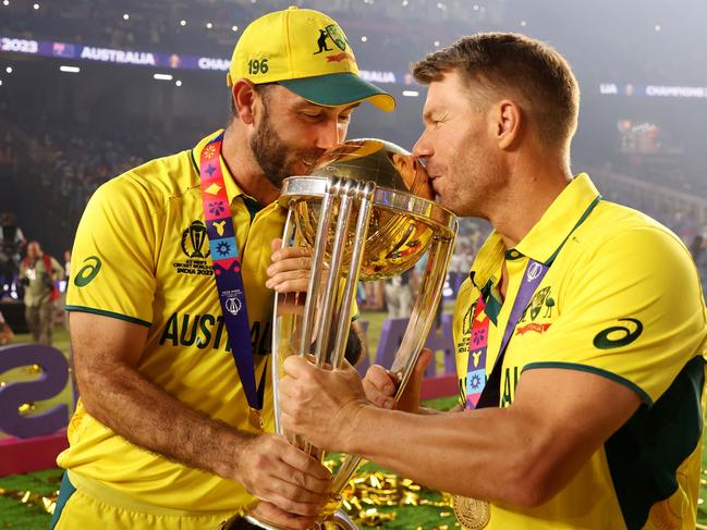 AHMEDABAD, INDIA - NOVEMBER 19: Glenn Maxwell and David Warner of Australia poses with the ICC Men's Cricket World Cup Trophy following the ICC Men's Cricket World Cup India 2023 Final between India and Australia at Narendra Modi Stadium on November 19, 2023 in Ahmedabad, India. (Photo by Robert Cianflone/Getty Images)