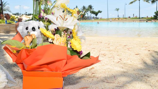 Tributes were left at Airlie Beach Lagoon after a Chinese man and his five-year-old son drowned in October 2018.