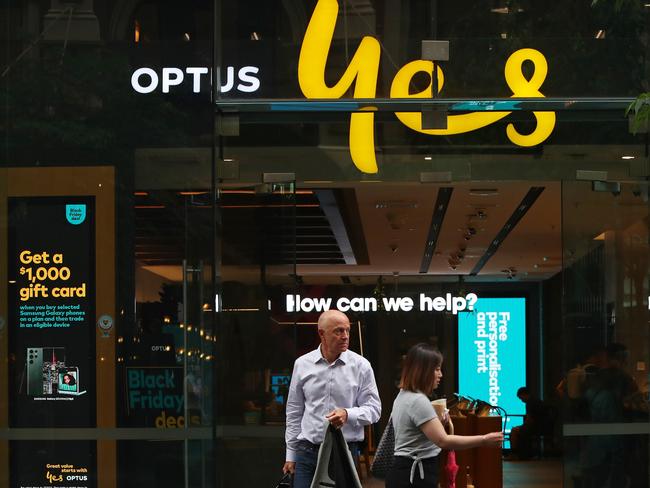 SYDNEY, AUSTRALIA - NOVEMBER 21: Pedestrians walk past an Optus store in the CBD on November 21, 2023 in Sydney, Australia. Optus' CEO Kelly Bayer Rosmarin stepped down on Monday after an extended outage last week caused millions of Australians to be disconnected from the network, with no access to emergency numbers for hours. The outage followed a hack that saw millions of customers' data shared online last year. (Photo by Lisa Maree Williams/Getty Images)