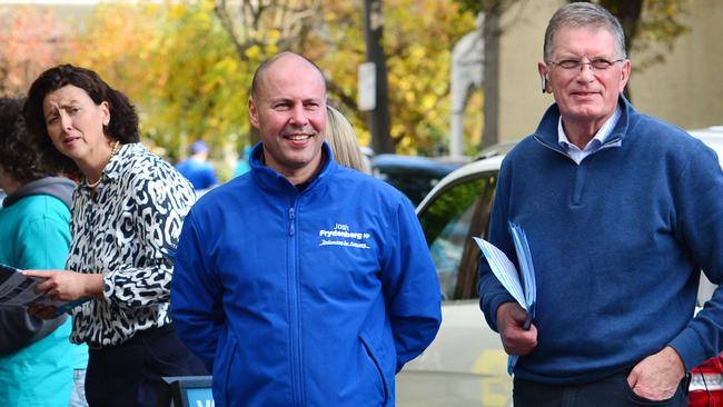 Josh Frydenberg, centre, visits the pre-polling booth in Hawthorn, Melbourne, with former Victorian premier Ted Baillieu and independent candidate Monique Ryan, left. Picture: Nicki Connolly