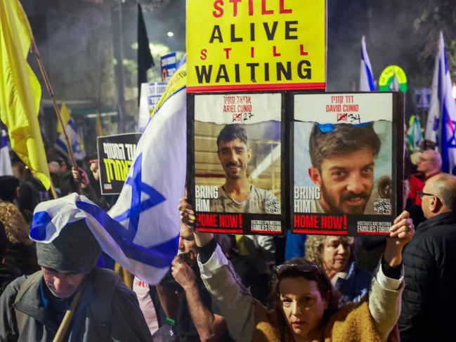 Relatives and supporters of Israelis held hostage in the Gaza Strip by Palestinian militants since October 2023, lift placards during a rally calling on the government for a deal that would bring all the remaining captives back, outside the prime minister residence in Jerusalem on March 2, 2025. (Photo by Menahem KAHANA / AFP)