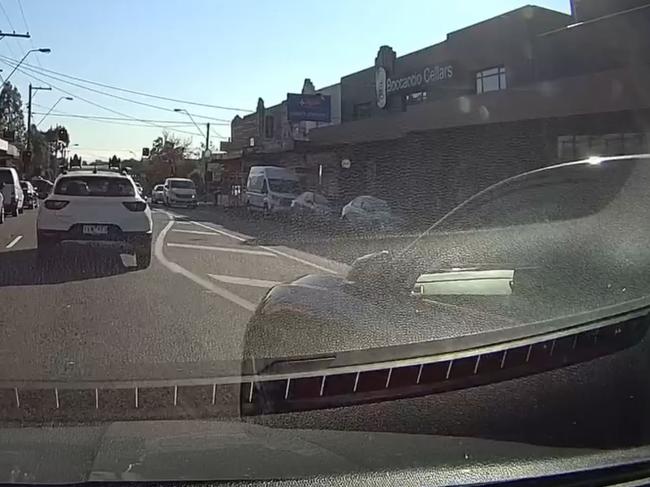 The red BMW merges, clipping the driver behind as she does so. Picture: Facebook