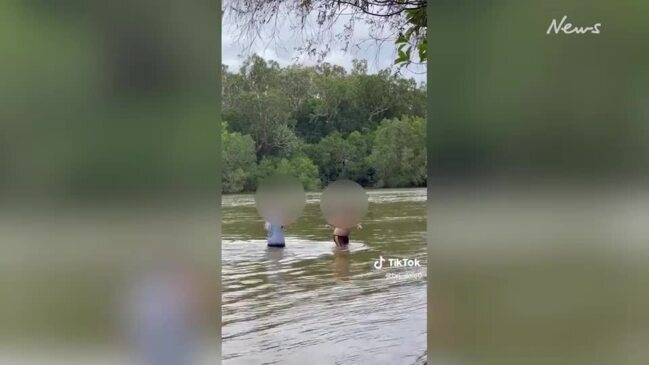 Pair wading in croc-infested Jardine River