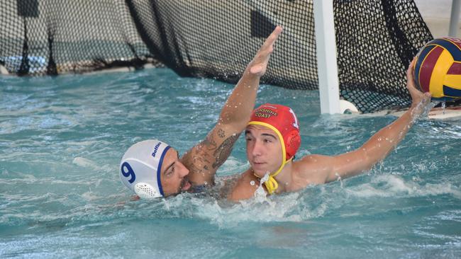 Water Polo Queensland Country Championships, 2nd World War Memorial Aquatic Centre, Rockhampton, February 18, 2023. Men, Mackay versus Sunshine Coast. Mackay player Clay Tucker and Sunshine Coast goalkeeper Archie Blackmore.