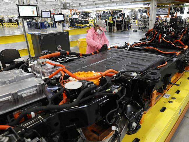 Electric car batteries are turning out to be very expensive to replace. A worker checks the cables on the battery for Ford Motor Co. battery powered F-150 Lightning trucks at Michigan Picture: AFP