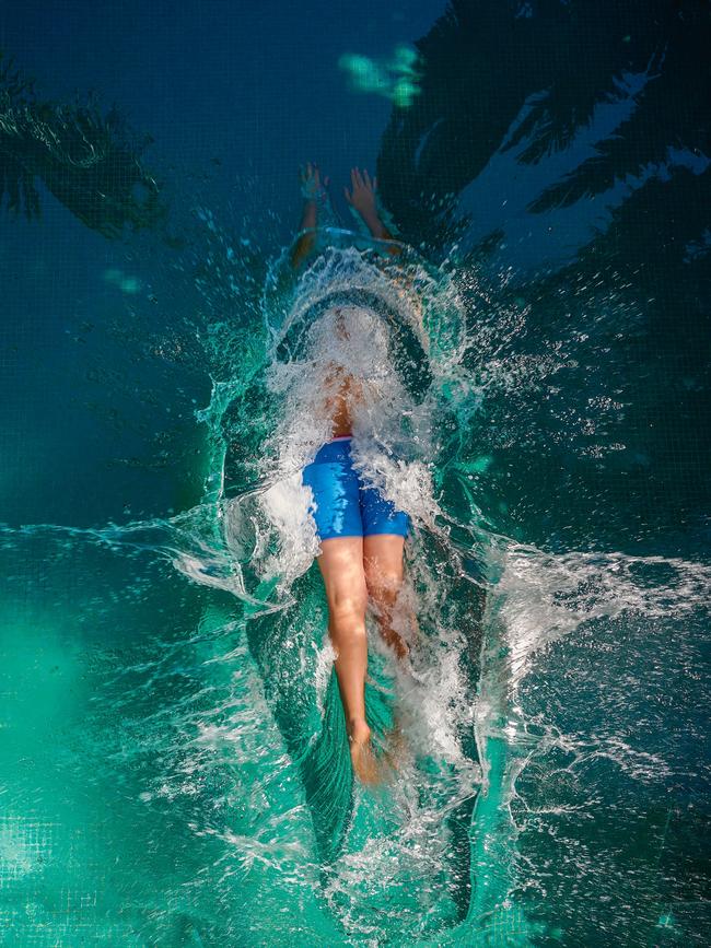 Collette Dinnigan’s son Hunter dives into the pool at the Darling Point house. Picture: Earl Carter