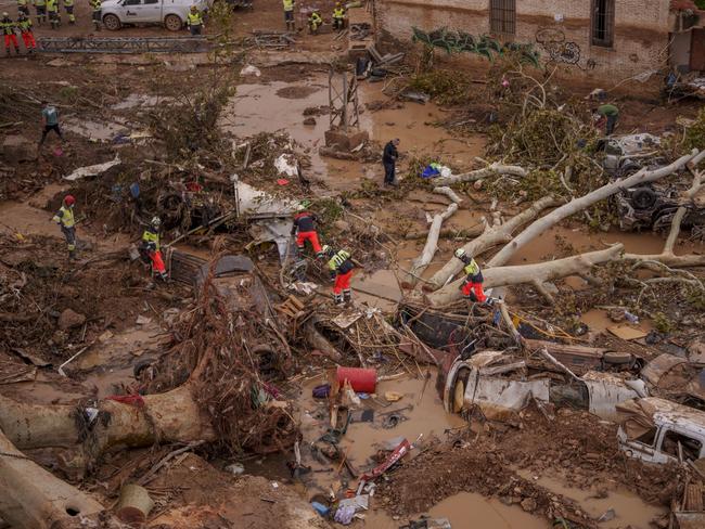 Emergency services remove cars in an area affected by floods in Catarroja, Spain. Picture: AP