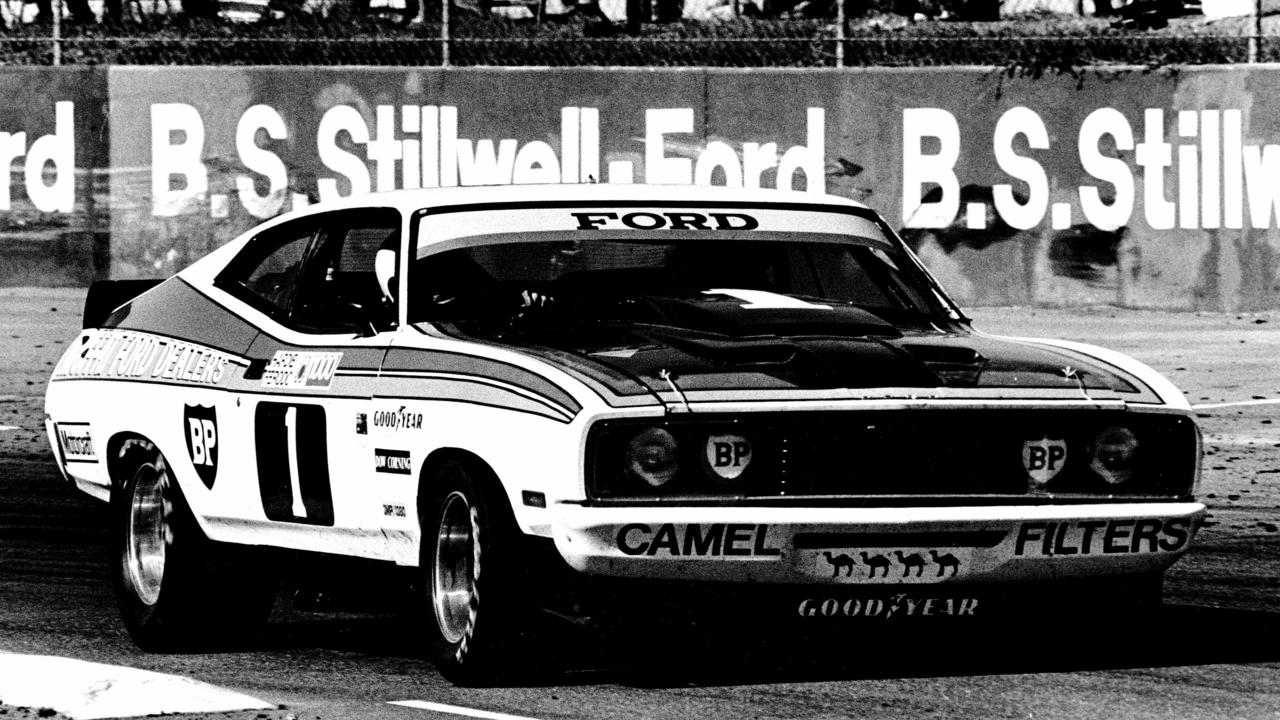 Racing driver Allan Moffat driving 1977 Ford Falcon XC coupe.