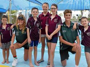 Rubbing shoulders with national swim champions Jaime Krueger and Tobias Street are Biggenden Swimming Club members, Luke Treloar, Lee Richmond, Madeleine and Sophia Radel and Flynn Richmond. Picture: Erica Murree