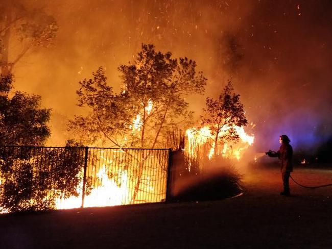 A supplied image obtained Tuesday, September 10, 2019 of firefighters battling a bushfire in Peregian Springs on the Sunshine Coast, Monday, September 9, 2019. (AAP Image/John Park) NO ARCHIVING, EDITORIAL USE ONLY