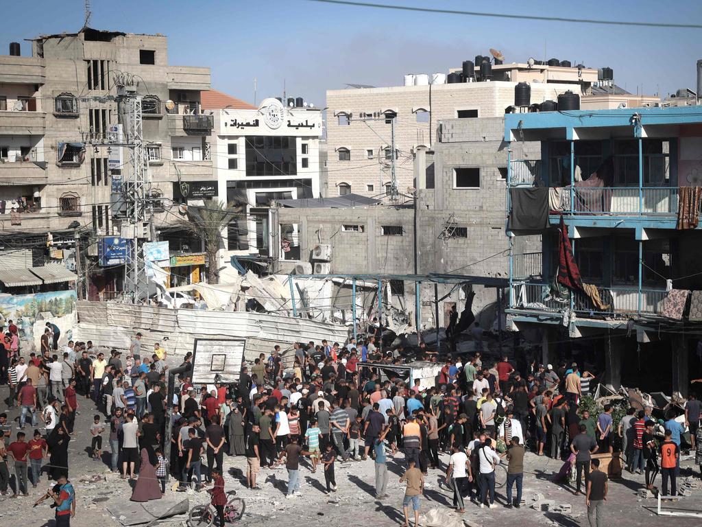 Palestinians in the courtyard of a school after an Israeli air strike hit the site, in Nuseirat in the central Gaza Strip. Picture: AFP