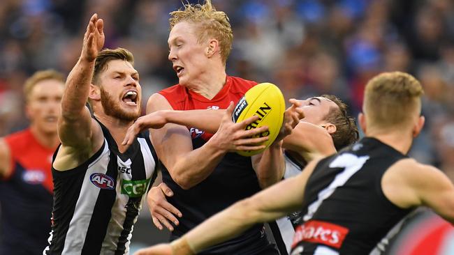 Clayton Oliver is tackled by Taylor Adams in the Queen’s Birthday clash.