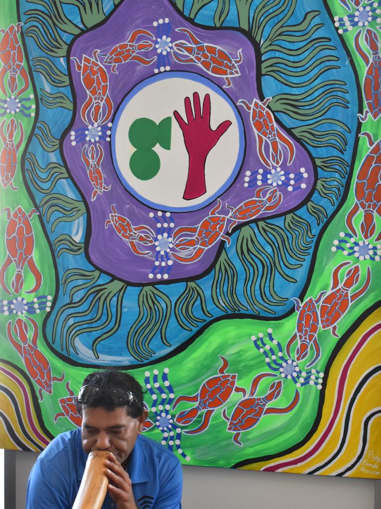 Local indigenous artist Byron Broome performs a welcome to country in front of one his inspiring paintings. Picture: Rhylea Millar.