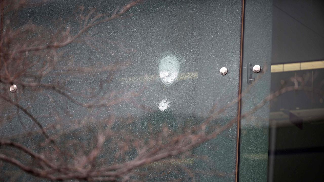 Images show bullet holes and smashed glass panels in the windows near the Qantas check-in counters. Picture: NCA NewsWire / Gary Ramage