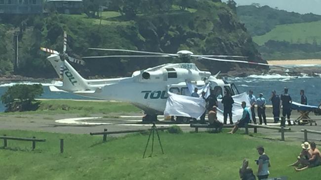 Paramedics and rescue helicopter personnel treat one of several victims at Kiama. Picture: Anita Balalovski 