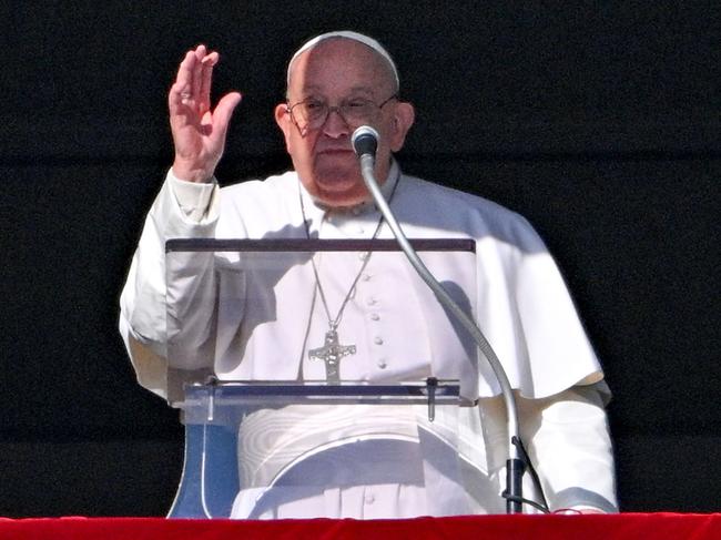 Pope Francis waves to the crowd from the window of the Apostolic Palace overlooking St. Peter's Square, during the Angelus prayer for the New Year in the Vatican on January 1, 2025. (Photo by Andreas SOLARO / AFP)