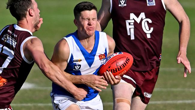 Sunbury skipper Daniel Tomas cops a low blow against Melton. Picture: Andy Brownbill