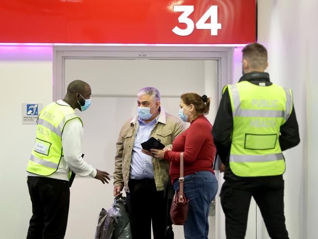 Public health officials check passengers from Melbourne arriving on flight VA819 landing at 9.10am at Sydney Airport have done their online travel declaration. Picture: NCA NewsWire / Damian Shaw