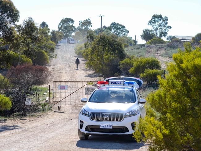 SA Police undertaking a large-scale search of a property in the Murray Mallee with an excavator in a bid to locate evidence believed to be linked with two murder inquiries, Wednesday, September 18, 2019. Police guard the front gate of the property. (Pic: AAP/Brenton Edwards)