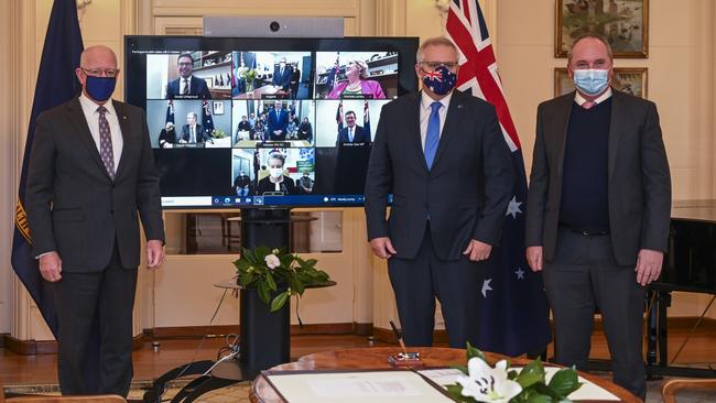 Governor-General David Hurley, left, with Scott Morrison and Barnaby Joyce at the virtual swearing-in ceremony. Picture: Martin Ollman