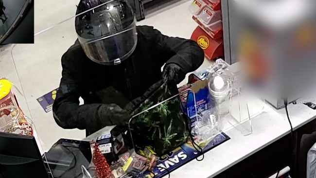 Police have released CCTV footage of a man wearing a black motorcycle helmet amid an investigation into an armed robbery at a service station in Sydney’s Epping in January. Picture: NSW Police