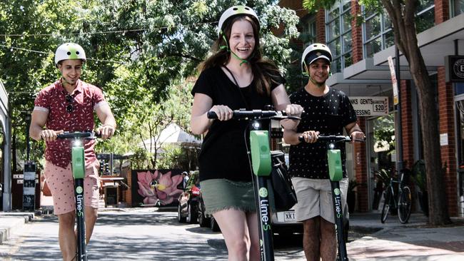 Ayman Kasim of Woodville, Natasha Taylor of Hallett Cove and Akram Kasim of Woodville riding the Lime Scooters. Picture: AAP Image/Morgan Sette