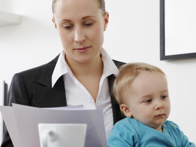 THINKSTOCK IMAGE Businesswoman working from home holding her baby son