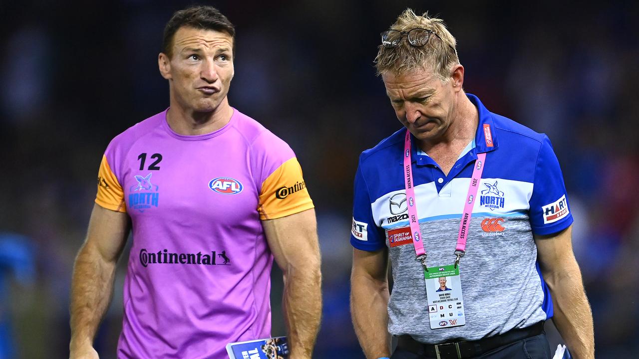 MELBOURNE, AUSTRALIA - APRIL 02: Brent Harvey and Kangaroos head coach David Noble walk off the field after losing the round 3 AFL match between the North Melbourne Kangaroos and the Western Bulldogs at Marvel Stadium on April 02, 2021 in Melbourne, Australia. (Photo by Quinn Rooney/Getty Images)